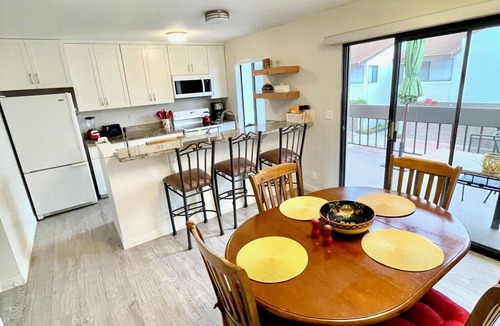 East Beach Condo | 2 bed spacious condo steps from beach + pool!