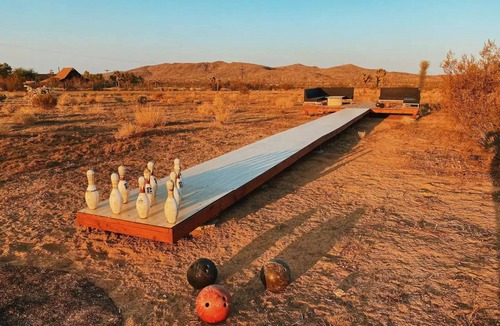 Yucca Valley House | 80s dreamworld with waterfall lagoon, bowling lane, hot tub under the Milky Way