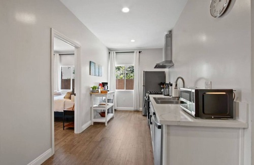 Azusa House | Cozy Urban Retreat: with King and Queen Beds, 1.5 Baths, Well-Equipped Kitchen, Private Backyard, and a Designated Parking Space.