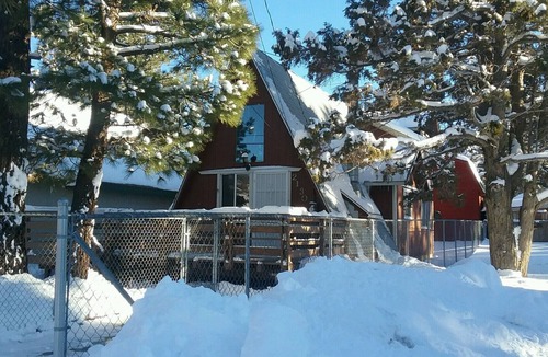 Woodlands Ski Chalet | Knotty Pine Chalet has a huge front deck and fully fenced yard .