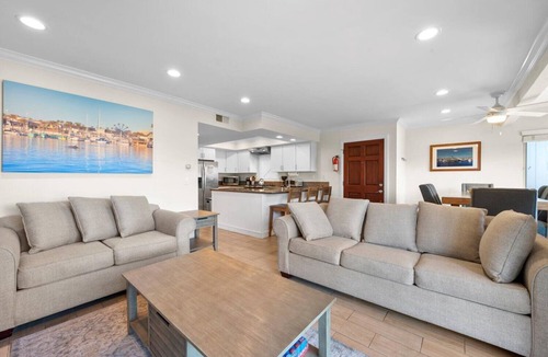 Balboa Peninsula Apartment | Oceanfront Boardwalk property, Newly remodeled Large patio, Steps to the sand.