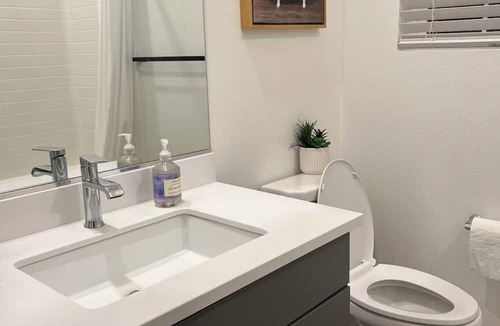 Upland House | Beautiful bedroom 02 with a private bathroom featuring a tub and shower.